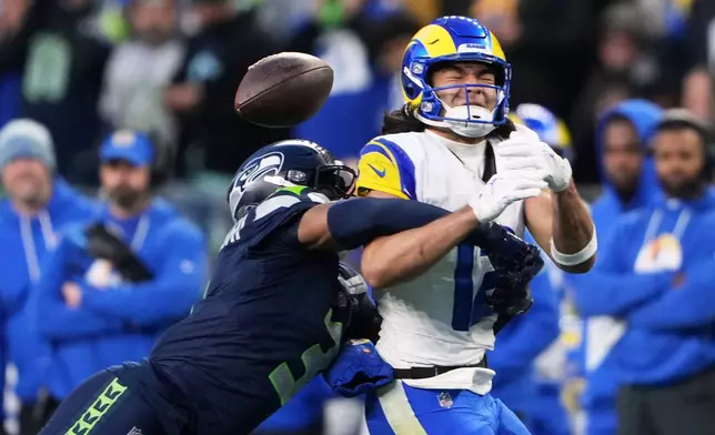 Seattle Seahawks safety Nick Emmanwori, left, breaks up a pass intended for Los Angeles Rams wide receiver Puka Nacua (12) during the first half of the NFC Championship NFL football game Sunday, Jan. 25, 2026, in Seattle. (AP Photo/Lindsey Wasson)