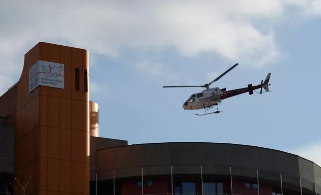 A helicopter takes off from the Hotel du Valais hospital in Sion, Switzerland, Friday, Jan. 2, 2026, following the fire at the "Le Constellation" bar and lounge in Crans-Montana, during the New Year celebration. (AP Photo/Baz Ratner)