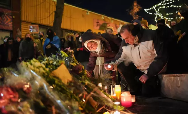 People gather during a vigil for 37-year-old Alex Pretti, who was fatally shot by a U.S. Border Patrol officer earlier in the day, Saturday, Jan. 24, 2026, in Minneapolis. (AP Photo/Adam Gray)