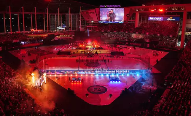 Players arrive before the NHL Winter Classic outdoor hockey game between the Florida Panthers and the New York Rangers, Friday, Jan. 2, 2026, in Miami. (AP Photo/Rebecca Blackwell)
