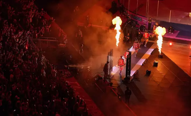 Florida Panthers players walk to the ice before the NHL Winter Classic outdoor hockey game between the Florida Panthers and the New York Rangers, Friday, Jan. 2, 2026, in Miami. (AP Photo/Rebecca Blackwell)