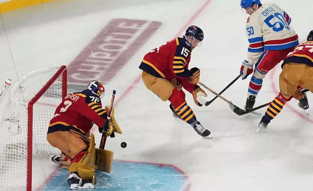 Florida Panthers goaltender Sergei Bobrovsky (72) blocks a shot attempt by the New York Rangers during the first period of the NHL Winter Classic outdoor hockey game, Friday, Jan. 2, 2026, in Miami. (AP Photo/Rebecca Blackwell)