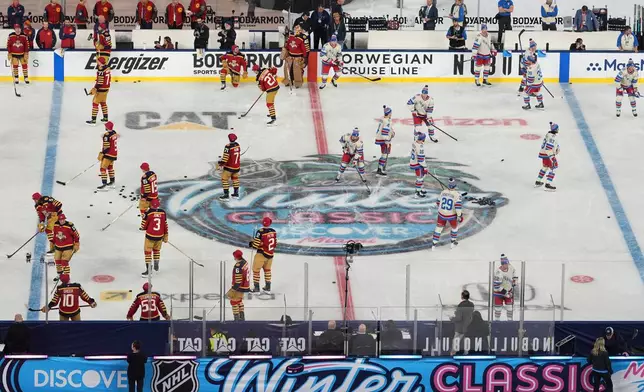 New York Rangers and Florida Panthers players warm up before the NHL Winter Classic outdoor hockey game, Friday, Jan. 2, 2026, in Miami. (AP Photo/Rebecca Blackwell)