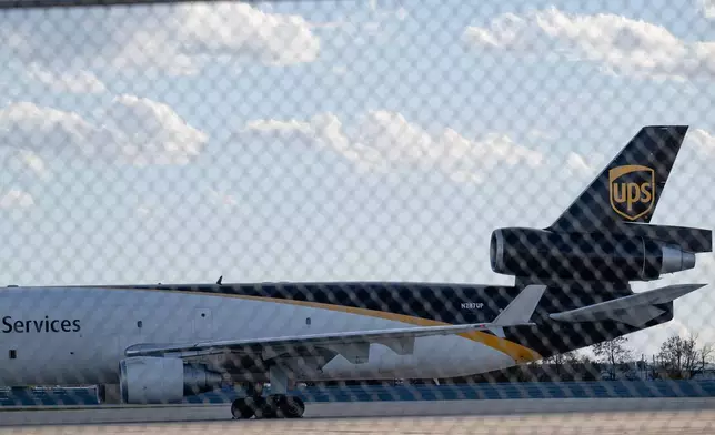 FILE - An MD-11F is seen parked at the UPS North Maintenance Hangar, Nov. 8, 2025, in Louisville, Ky. (AP Photo/Jon Cherry, File)