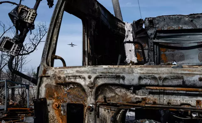 A UPS Boeing 737 takes over a destroyed truck during a tour of the UPS plane crash site, Tuesday, Jan. 13, 2026, in Louisville, Ky. (AP Photo/Jon Cherry)