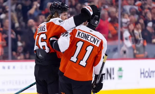 Philadelphia Flyers' Trevor Zegras, left, celebrates with Travis Konecny, right, after scoring his second goal of the period during the first period of an NHL hockey game against the Anaheim Ducks, Tuesday, Jan. 6, 2026, in Philadelphia. (AP Photo/Chris Szagola)