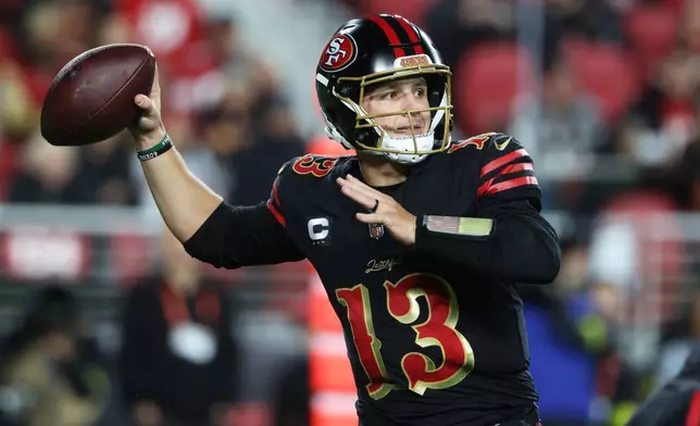 San Francisco 49ers quarterback Brock Purdy (13) passes against the Seattle Seahawks during the second half of an NFL football game in Santa Clara, Calif., Saturday, Jan. 3, 2026. (AP Photo/Jed Jacobsohn)