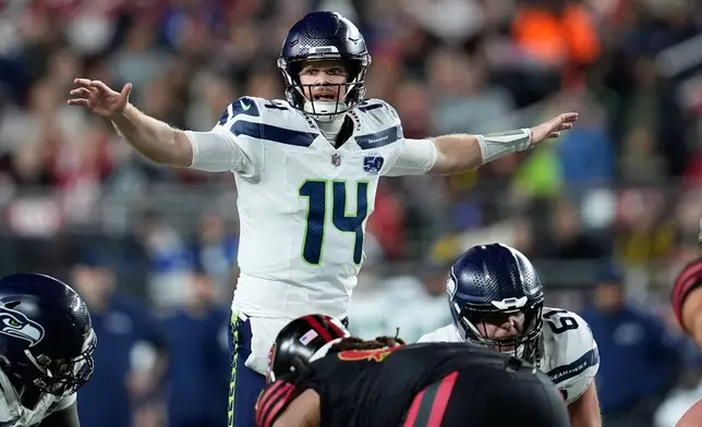 Seattle Seahawks quarterback Sam Darnold (14) signals at the line of scrimmage during the first half of an NFL football game against the San Francisco 49ers in Santa Clara, Calif., Saturday, Jan. 3, 2026. (AP Photo/Godofredo A. Vásquez)