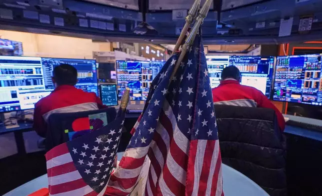 A pair of traders work on the floor of the New York Stock Exchange, Monday, Jan. 12, 2026. (AP Photo/Richard Drew)