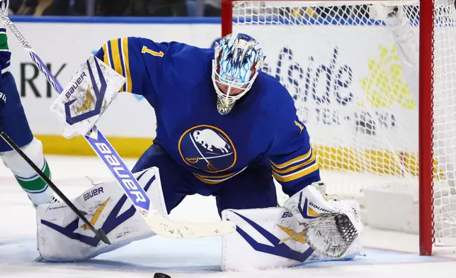 Buffalo Sabres goaltender Ukko-Pekka Luukkonen (1) covers the puck during the second period of an NHL hockey game against the Vancouver Canucks Tuesday, Jan. 6, 2026, in Buffalo, N.Y. (AP Photo/Jeffrey T. Barnes)