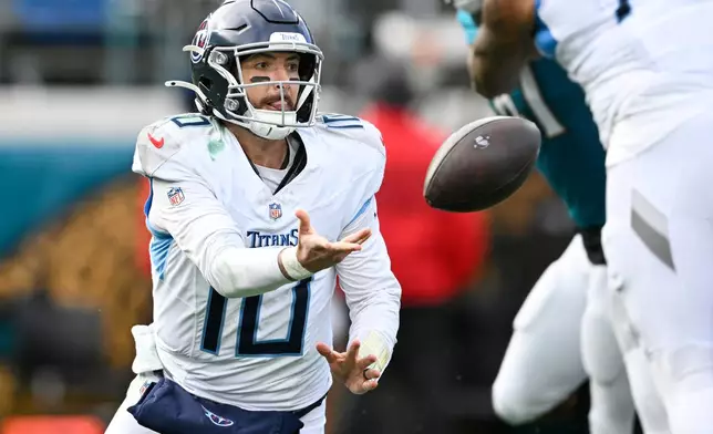 Tennessee Titans quarterback Brandon Allen (10) tosses the ball as he falls to the ground during the second half of an NFL football game, against the Jacksonville Jaguars, Sunday, Jan. 4, 2026, in Jacksonville, Fla. (AP Photo/Phelan M. Ebenhack)