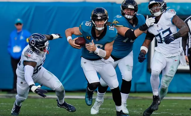 Jacksonville Jaguars quarterback Trevor Lawrence (16) runs the ball past Tennessee Titans outside linebackers Truman Jones (56) and Jaylen Harrell, far right, during the second half of an NFL football game Sunday, Jan. 4, 2026, in Jacksonville, Fla. (AP Photo/John Raoux)
