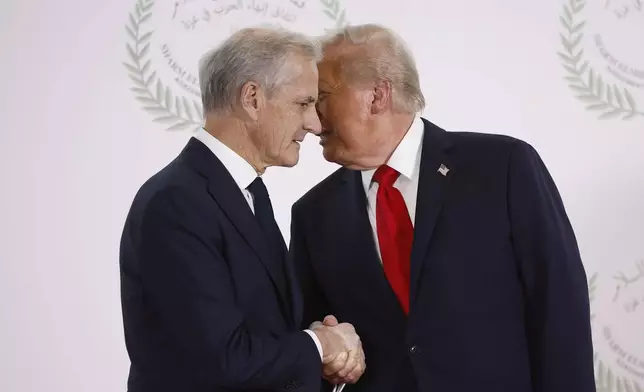 FILE - President Donald Trump and Norway's Prime Minister Jonas Gahr Store shake hands during the group photo at the Gaza International Peace Summit in Sharm el-Sheikh, Egypt, Oct.13 2025. (Yoan Valat, Pool photo via AP, File)