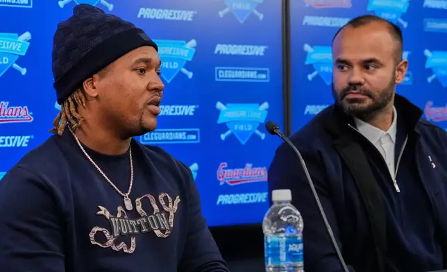 Cleveland Guardians third baseman Jose Ramirez, left, speaks as Agustin Rivero, right, Guardiansmajor league coach &amp; Spanish interpreter, looks on during a news conference to announce his contract extension in Cleveland, Thursday, Jan. 29, 2026. (AP Photo/Sue Ogrocki)