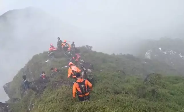 In this photo provided by the Indonesian National Search and Rescue Agency (BASARNAS), members of its rescue team conduct a searching operation around Mount Bulusaraung, South Sulawesi province, Indonesia, Saturday, Jan. 17, 2026, after a passenger aircraft lost contact while approaching the mountainous region between Indonesia’s main island of Java and Sulawesi island. (BASARNAS via AP)