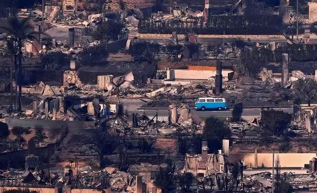 FILE - A bus sits among burned out homes, Jan. 9, 2025, in Malibu, Calif. (AP Photo/Mark J. Terrill, File)