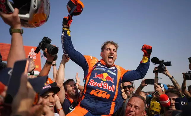 Rider Luciano Benavides of Argentina celebrates after the thirteenth stage with a start and finish in Yanbu, Saudi Arabia, Saturday, Jan.17, 2026. (AP Photo/Thibault Camus)