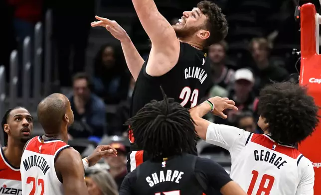 Portland Trail Blazers center Donovan Clingan (23) makes a basket during the first half of an NBA basketball game against the Washington Wizards, Tuesday, Jan. 27, 2026, in Washington. (AP Photo/John McDonnell)