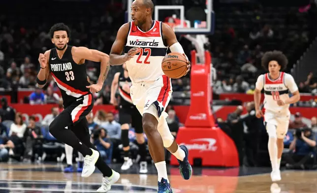 Washington Wizards forward Khris Middleton (22) dribbles down court against Portland Trail Blazers forward Toumani Camara (33) during the first half of an NBA basketball game, Tuesday, Jan. 27, 2026, in Washington. (AP Photo/John McDonnell)