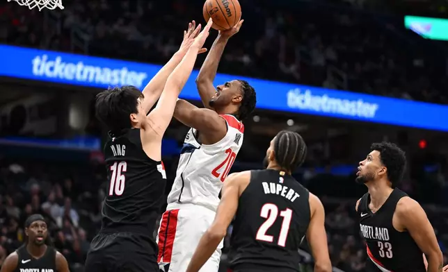 Washington Wizards center Alex Sarr goes to shoot over Portland Trail Blazers center Yang Hansen (16) during the first half of an NBA basketball game, Tuesday, Jan. 27, 2026, in Washington. (AP Photo/John McDonnell)