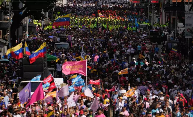 Government supporters gather for a women's march to demand the return of Venezuelan President Nicolas Maduro in Caracas, Venezuela, Tuesday, Jan. 6, 2026, three days after U.S. forces captured him and his wife. (AP Photo/Matias Delacroix)