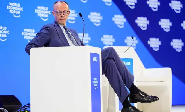 German Chancellor Friedrich Merz sits on the podium during the Annual Meeting of the World Economic Forum in Davos, Switzerland, Thursday, Jan. 22, 2026. (AP Photo/Markus Schreiber)