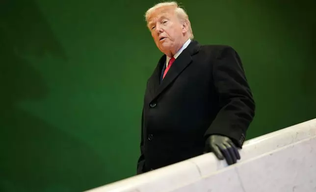 President Donald Trump walks down stairs after a meeting during the Annual Meeting of the World Economic Forum in Davos, Switzerland, Wednesday, Jan. 21, 2026. (AP Photo/Markus Schreiber)