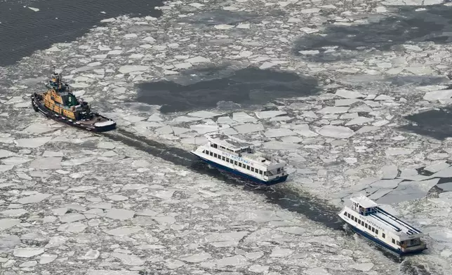New York Waterway ferries move as ice floats on the Hudson River seen from the Edge sky deck at Hudson Yards, Tuesday, Jan. 27, 2026, in New York. (AP Photo/Yuki Iwamura)