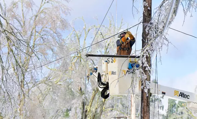 A lineman works to restore power in Oxford, Miss. on Monday, Jan. 26, 2026, following a weekend ice storm. (AP Photo/Bruce Newman)
