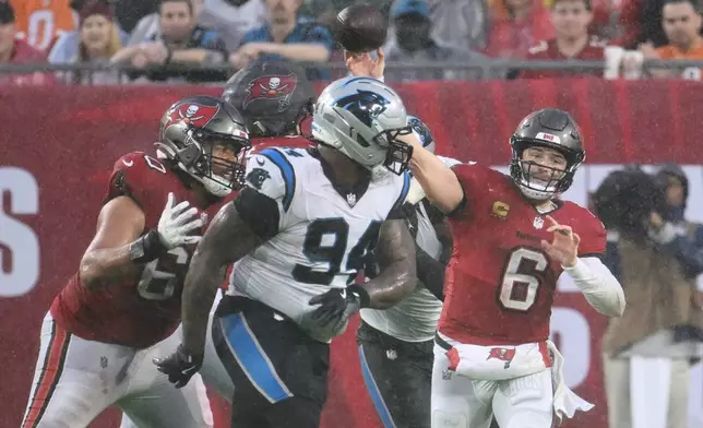 Tampa Bay Buccaneers quarterback Baker Mayfield (6) throws an interception during the first half of an NFL football game against the Carolina Panthers Saturday, Jan. 3, 2026, in Tampa, Fla. (AP Photo/Jason Behnken)