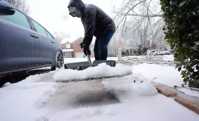 Ice and snow are shoveled during a winter storm Sunday, Jan. 25, 2026, in Nashville, Tenn. (AP Photo/George Walker IV, File)