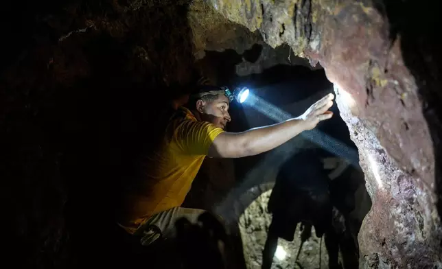 Miner Gerson Flores works inside an undground a gold mine pit in El Callao, Venezuela, Tuesday, Jan. 22, 2026. (AP Photo/Matias Delacroix)