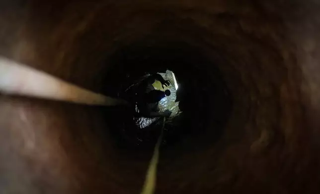 A miner descends into a gold mine pit in El Callao, Venezuela, Tuesday, Jan. 22, 2026. (AP Photo/Matias Delacroix)