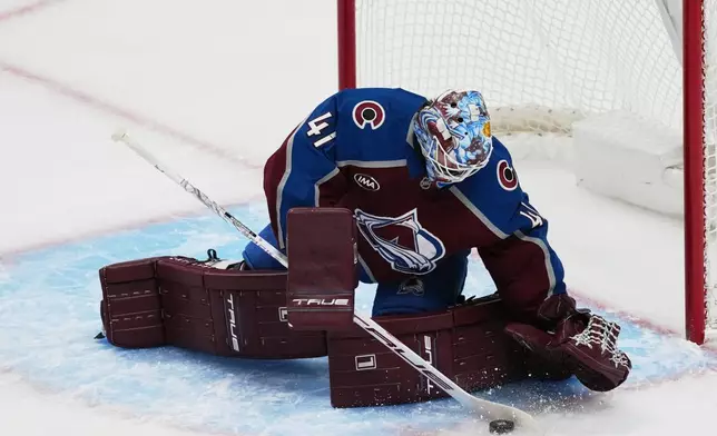 Colorado Avalanche goaltender Scott Wedgewood makes a stick save of a shot from the Anaheim Ducks in the first period of an NHL hockey game Wednesday, Jan. 21, 2026, in Denver. (AP Photo/David Zalubowski)