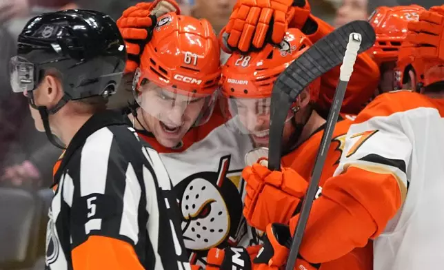 Anaheim Ducks left wing Cutter Gauthier, left, congratulates left wing Jeffrey Viel after his goal agaist the Colorado Avalanche in the second period of an NHL hockey game Wednesday, Jan. 21, 2026, in Denver. (AP Photo/David Zalubowski)
