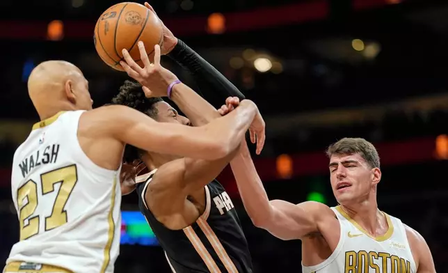 Atlanta Hawks forward Jalen Johnson (1) shoots against Boston Celtics guard Jordan Walsh (27) during the first half of an NBA basketball game, Saturday, Jan. 17, 2026, in Atlanta. (AP Photo/Mike Stewart)