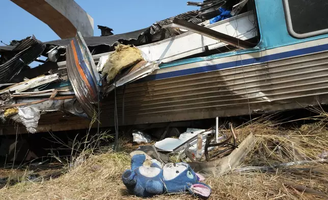 A cuddly toy lies on the ground at the site of a train accident, a day after a construction crane fell into a passenger train in Nakhon Ratchasima province, Thailand, Thursday, Jan. 15, 2026. (AP Photo/Sakchai Lalit)