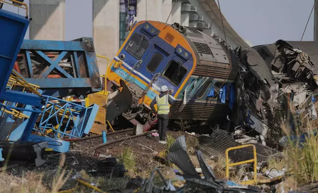 The wreckage after a construction crane fell into a passenger train in Nakhon Ratchasima province, Thailand, Wednesday, Jan.14, 2026. (AP Photo/Sakchai Lalit))