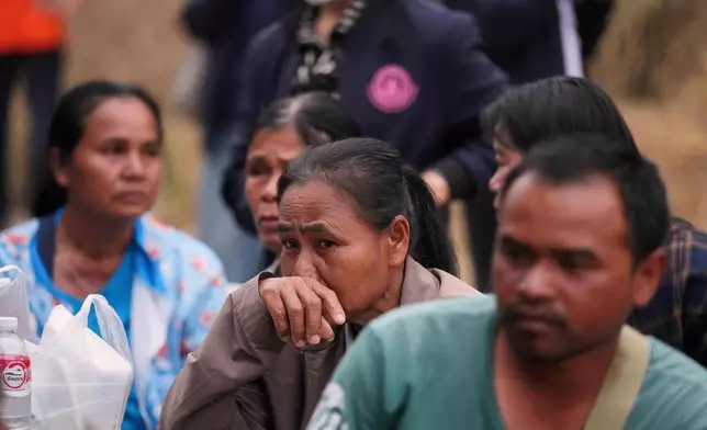 Relatives of victims and others react after a construction crane fell into a passenger train in Nakhon Ratchasima province, Thailand, Wednesday, Jan.14, 2026. (AP Photo/Sakchai Lalit))
