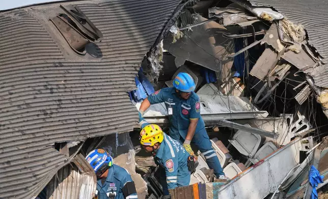 Rescuers work amidst the wreckage after a construction crane fell into a passenger train in Nakhon Ratchasima province, Thailand, Wednesday, Jan.14, 2026. (AP Photo/Sakchai Lalit))