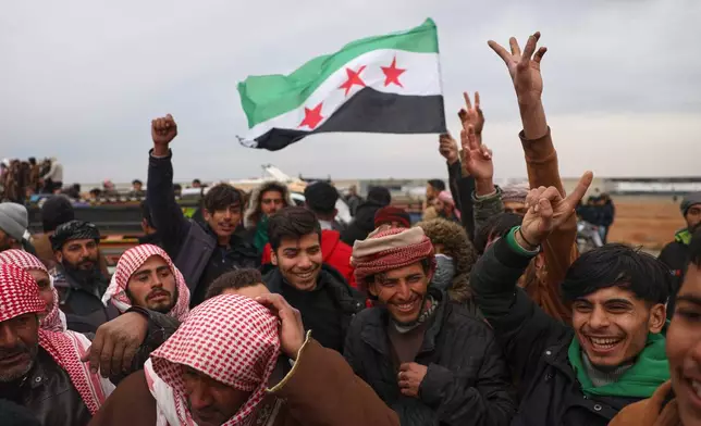 People celebrate as Syrian government forces enter the town of Maskana, Saturday, Jan. 17, 2026, following the withdrawal of the U.S.-backed Syrian Democratic Forces. (AP Photo/Omar Albam)