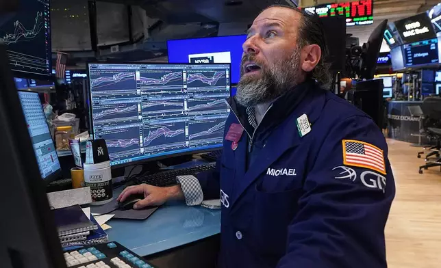 Specialist Michael Pistillo works at his post on the floor of the New York Stock Exchange, Monday, Jan. 12, 2026. (AP Photo/Richard Drew)