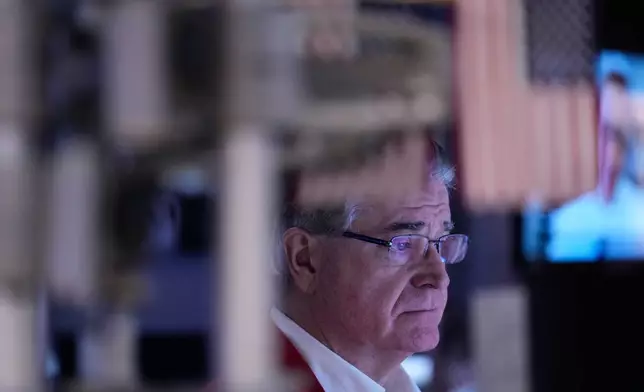 Daniel Kryger works on the floor at the New York Stock Exchange in New York, Friday, Jan. 9, 2026. (AP Photo/Seth Wenig)