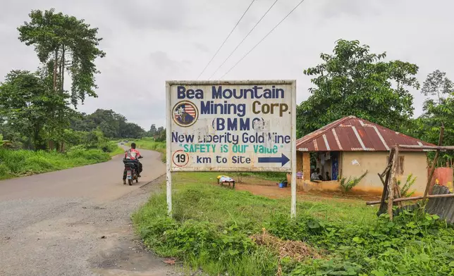 A sign gives directions to the New Liberty Gold Mine, operated by Bea Mountain Mining Corporation, in Grand Cape Mount County, Liberia, July 7, 2025. (AP Photo/Misper Apawu)