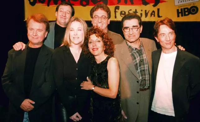 FILE - Former cast members of SCTV, from left, Dave Thomas, Joe Flaherty, Catherine O'Hara, Andrea Martin, foreground, Harold Ramis, Eugene Levy and Martin Short, pose at the U.S. Comedy Arts Festival on March 6, 1999, in Aspen, Colo. (AP Photo/E Pablo Kosmicki, File)