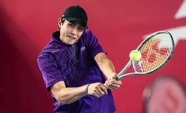Local up and coming junior KaiThompson hits a backhand return during his first round doubles match with China’s Yi Zhou against Theo Arribage and Albano Olivetti of France. (Photo by Lampson Yip / HKCTA)