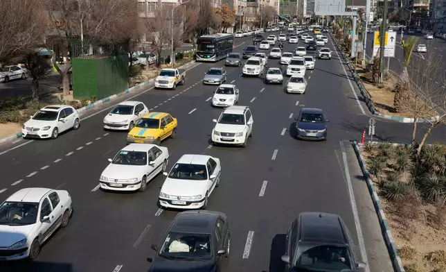 Vehicles drive in downtown Tehran, Iran, Friday, Jan. 16, 2026. (AP Photo/Vahid Salemi)