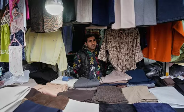 A shopkeeper waits for customer at Tehran's historic Grand Bazaar, Tuesday, Jan. 20, 2026, in Iran. (AP Photo/Vahid Salemi)