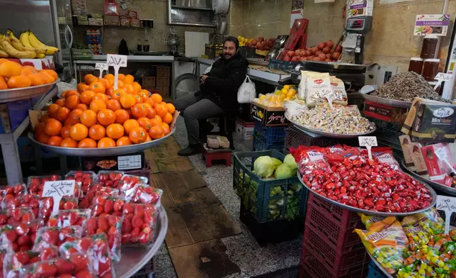 A fruit seller waits for customer at Tehran's historic Grand Bazaar, Tuesday, Jan. 20, 2026, in Iran. (AP Photo/Vahid Salemi)