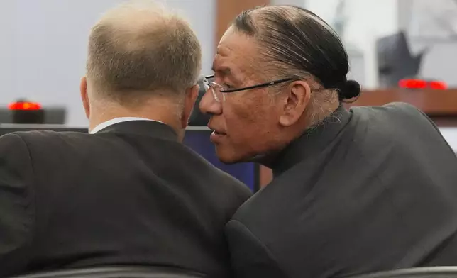 Nathan Chasing Horse, right, talks to his attorney Craig Mueller during his trial on charges of sexually abusing Indigenous women and girls Tuesday, Jan. 13, 2026, in Las Vegas. (AP Photo/Ty ONeil)
